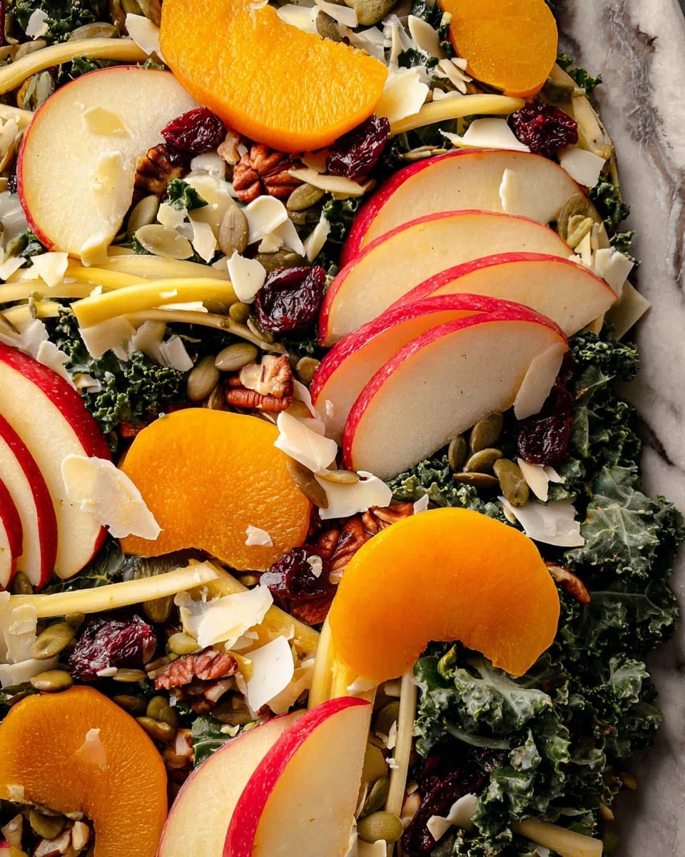The image shows a close-up of a colorful salad spread over a white marbled surface. The salad has layers starting with dark green, wrinkled kale leaves as the base. On top, there are thin, pale yellow to white slices of fennel mixed throughout. Bright orange slices of persimmon and thin, red-edged slices of apple are arranged in clusters across the salad. Scattered among the greens and fruits are small reddish-brown pecans, dark red dried cranberries, pale green pumpkin seeds, and white shaved cheese pieces giving a slightly rough texture. Photo taken with an iphone --ar 4:5 --v 7