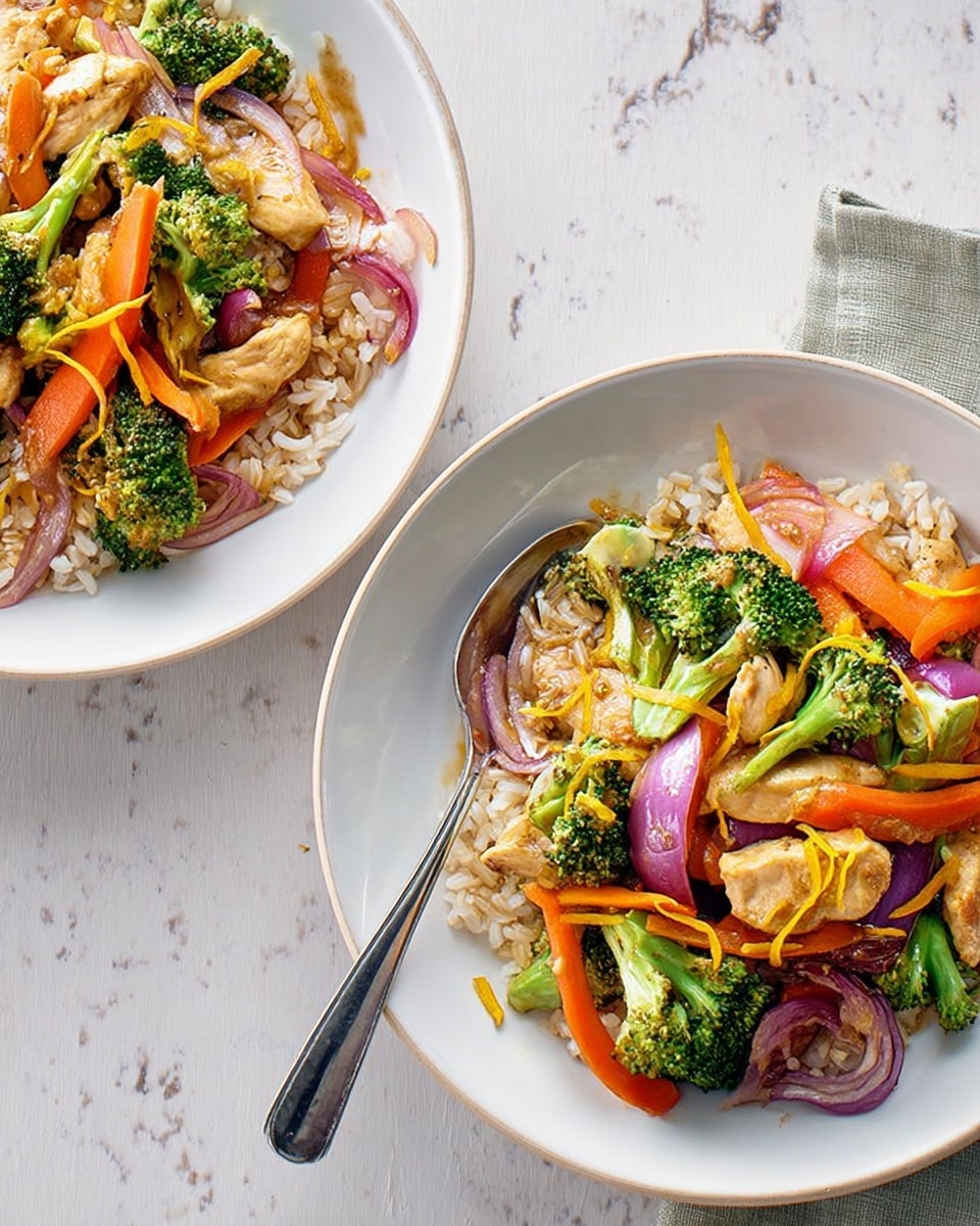 Two white plates rest on a white marbled surface, each filled with three layers of food. The bottom layer is light brown rice spread evenly across the plate. The middle layer has bright green broccoli florets and thin orange carrot slices scattered around. The top layer features cooked chicken pieces with a golden-brown color and several purple-red onion slices. A silver fork is placed on one of the plates, tucked under some chicken and vegetables. Nearby, a green cloth napkin lies partially under the second plate. Photo taken with an iphone --ar 4:5 --v 7