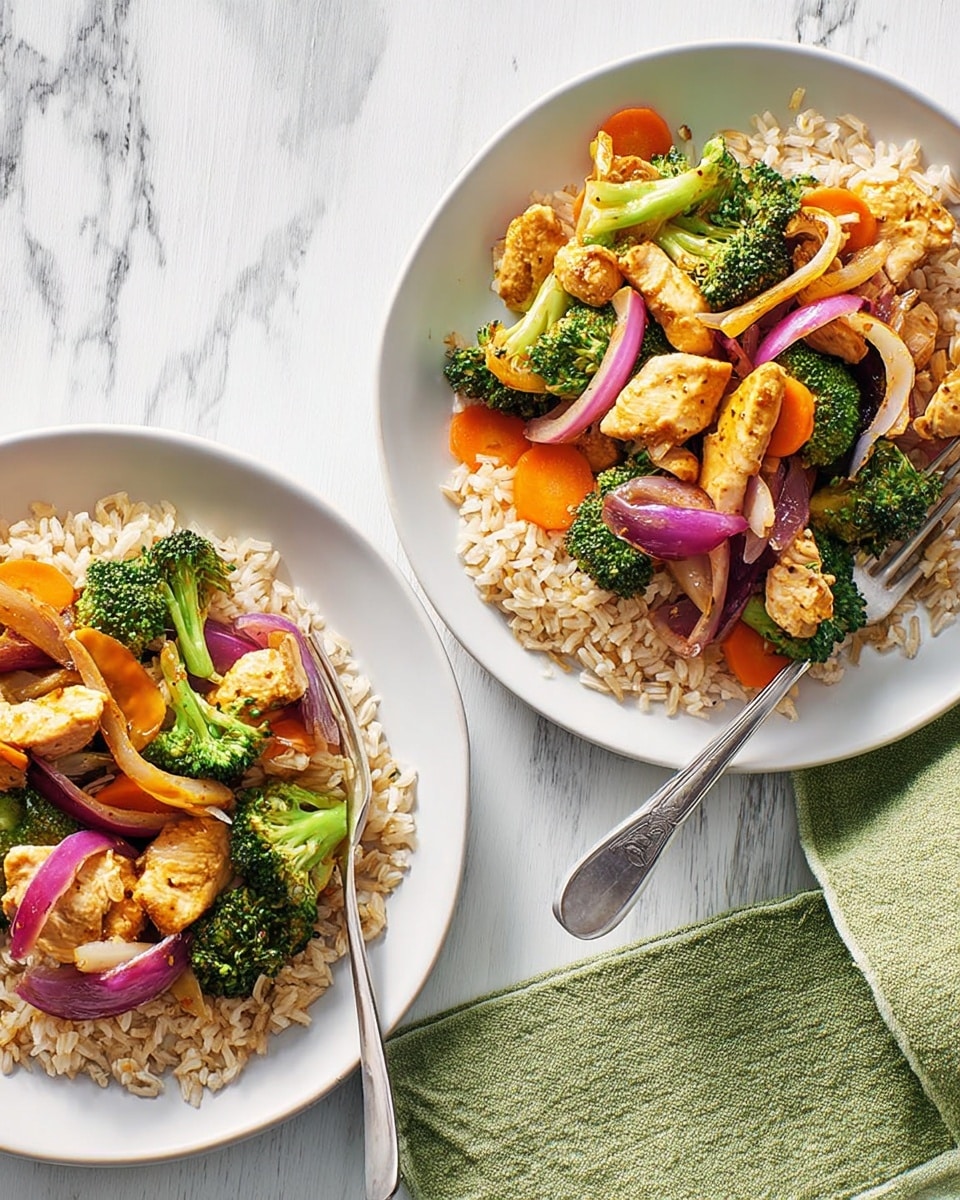 Two white plates sit on a white marbled surface, each holding a colorful dish. At the bottom is a layer of light brown rice. On top of the rice are bright green broccoli florets, thin orange carrot slices, and thick strips of purple onion, all mixed together with light brown cooked chicken pieces. Thin yellow strips, possibly ginger or zest, lay scattered across the vegetables and chicken. A silver spoon rests on the lower plate, placed partially into the food. The second plate is partially shown with similar contents and has a silver fork resting on its edge. Photo taken with an iphone --ar 4:5 --v 7